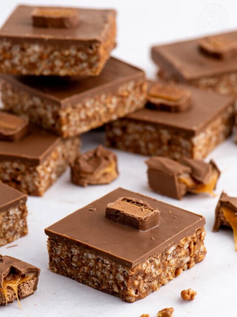 Homemade Mars Bar Slice with a chocolate rice crispy base, topped with smooth milk chocolate and pieces of Mars Bar.