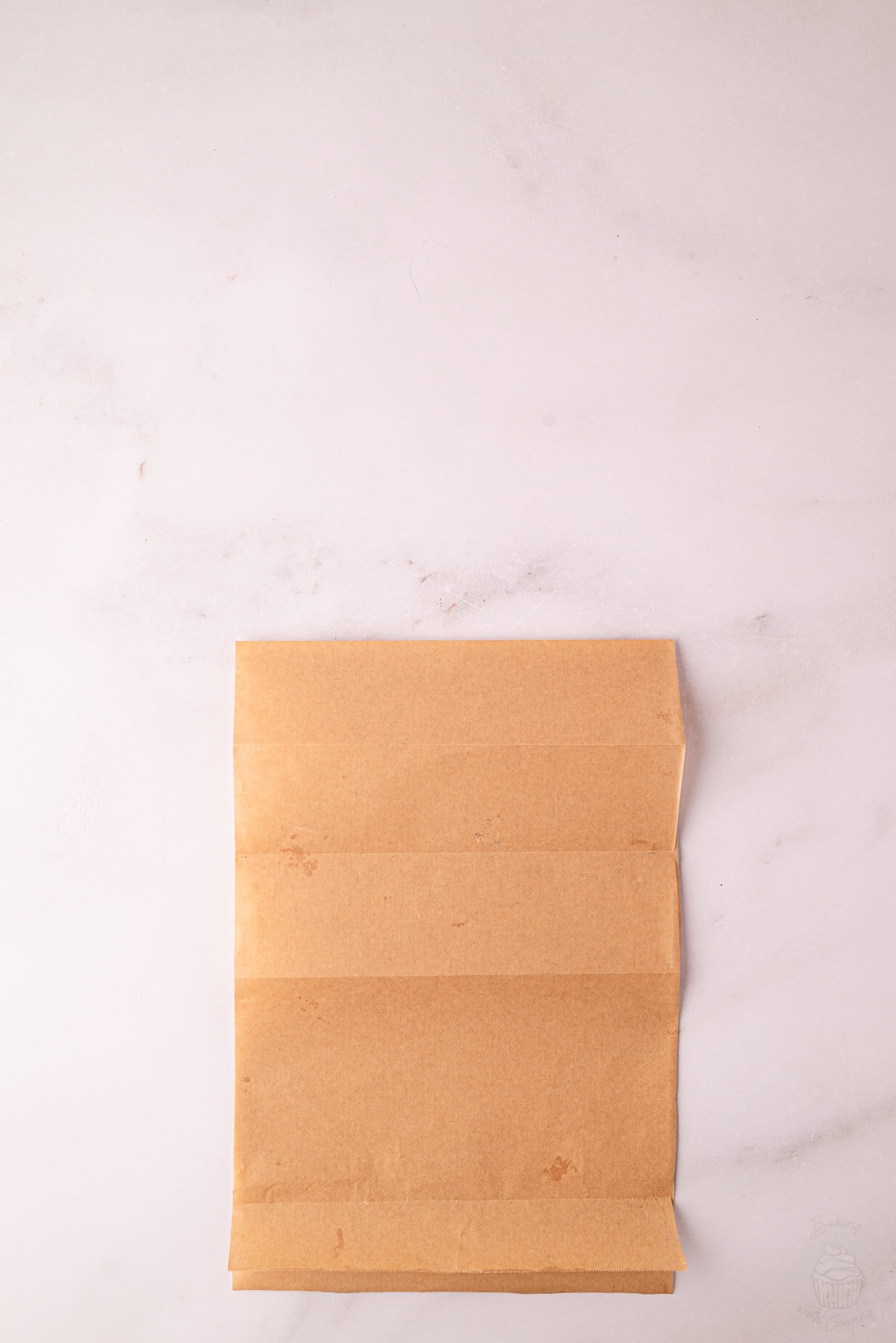 Greaseproof paper folded to mark the centre section for Angel Cake batter.