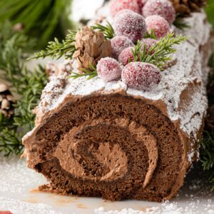 Chocolate Yule Log covered with chocolate buttercream and dusted with icing sugar.