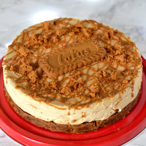 No-bake Biscoff cheesecake topped with a whole Lotus biscuit, Biscoff drizzle and crushed Biscoff crumbs.