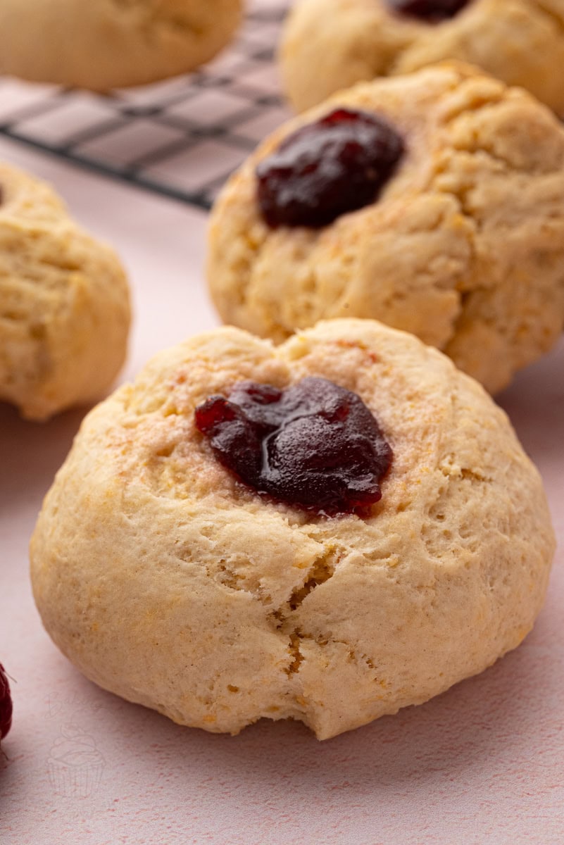 Close-up of a traditional British rasp bun with raspberry jam baked into the centre.
