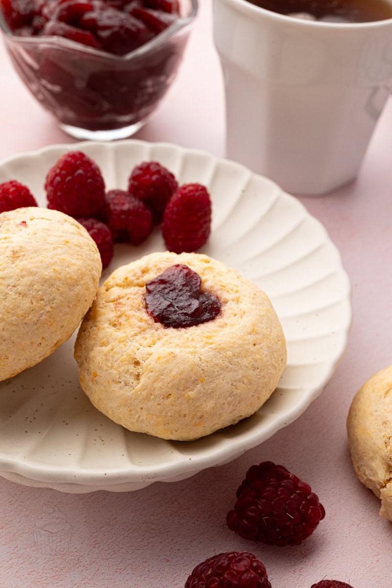 Rasp buns arranged on a wire cooling rack viewed from above.