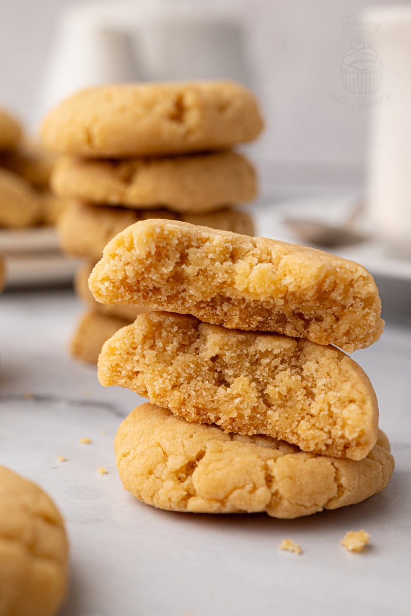 Close-up of golden gingernut biscuits showing their cracked, crunchy surface.