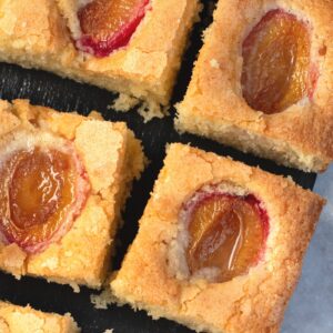 Plum cake with jammy baked plum halves in a golden vanilla sponge.