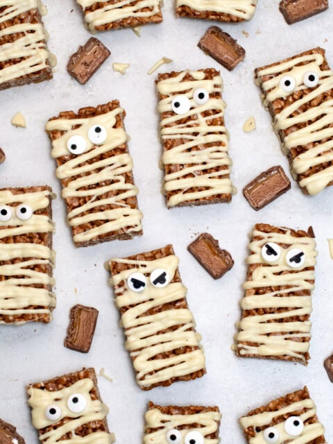 Mummy Mars Bar Slices decorated with white chocolate bandages and edible eyes.