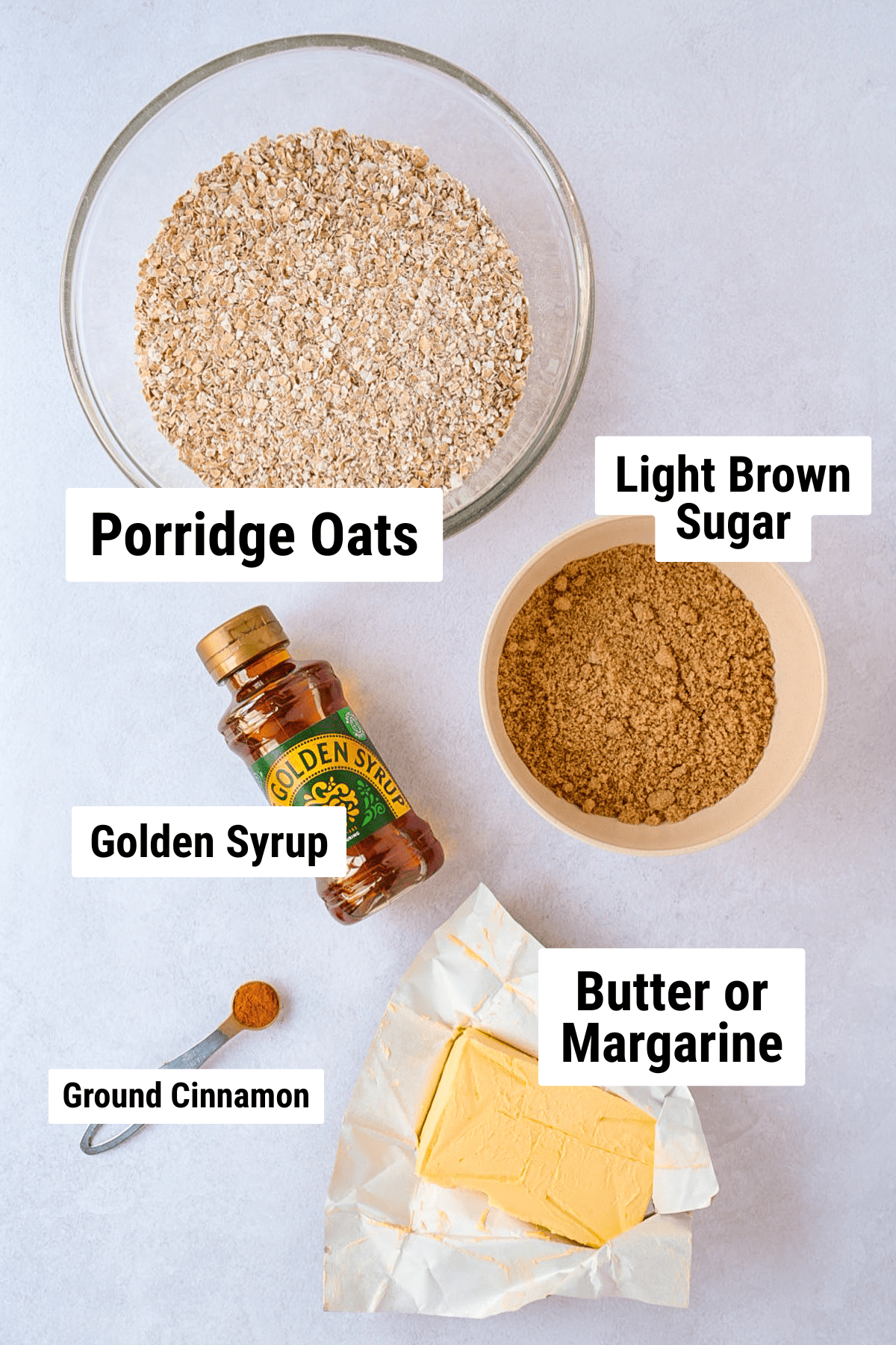 Ingredients for British flapjack: porridge oats, brown sugar, golden syrup, butter and cinnamon.