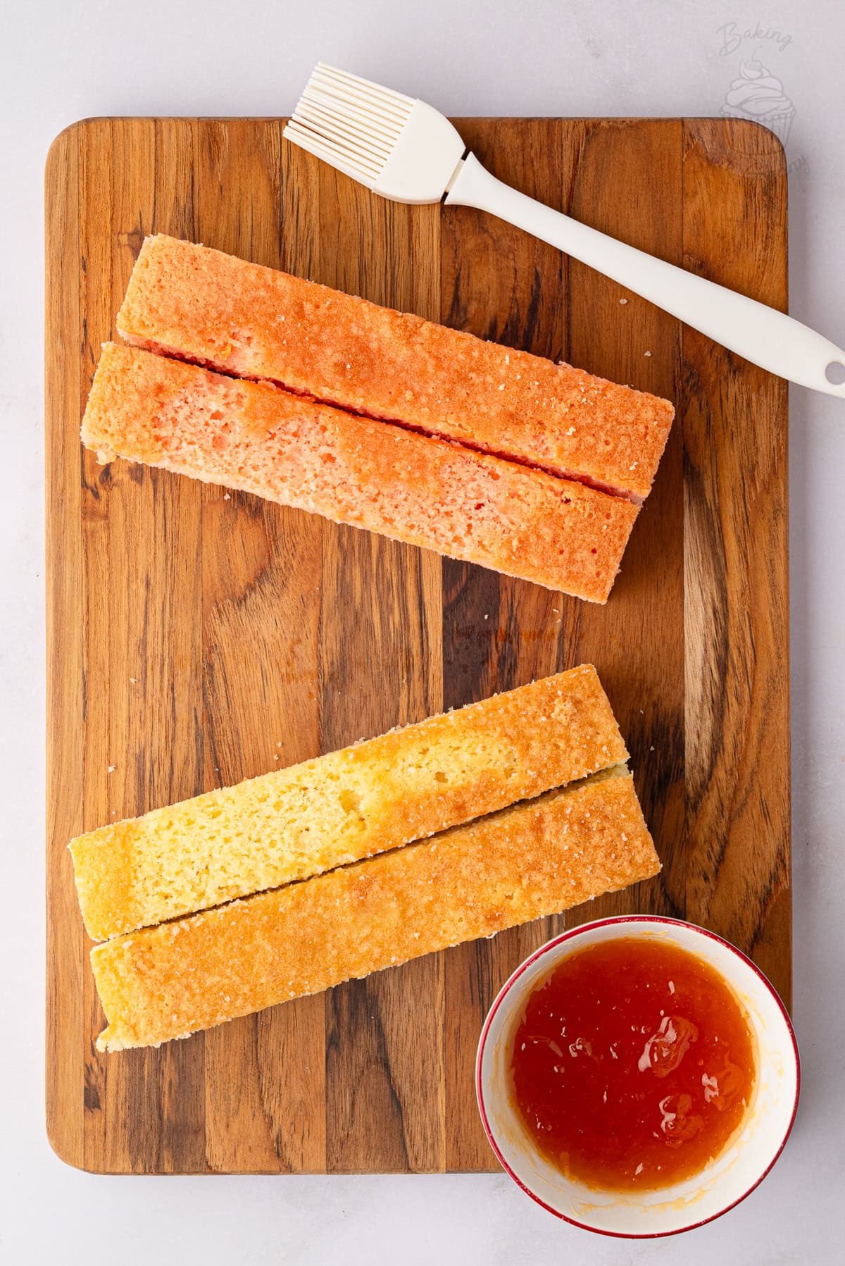 Pink and plain Battenberg sponges trimmed into four even strips.