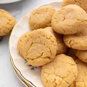Golden Gingernut biscuits showing their cracked, crisp and crunchy surface.