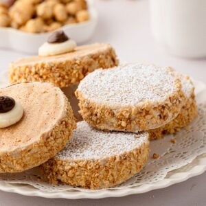 Scottish Japonaise biscuits with hazelnut-coated buttercream sides and piped decoration.