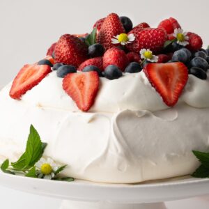 Pavlova with whipped cream and fresh berries.