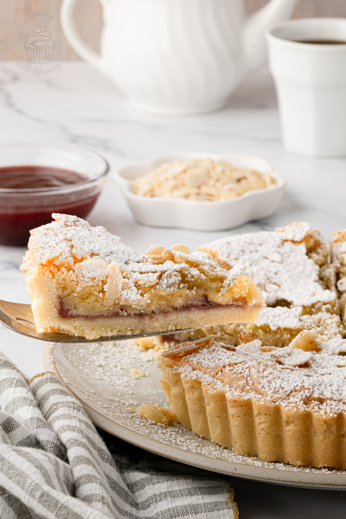 Slice of Bakewell Tart showing the raspberry jam and soft almond frangipane.