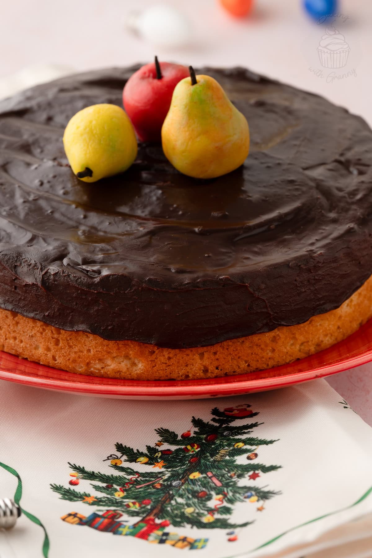 Tunis Cake topped with dark chocolate ganache and marzipan apple, pear and lemon.