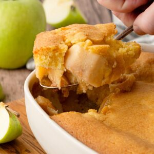 Freshly baked Eve’s Pudding with golden sponge, green apples and custard.
