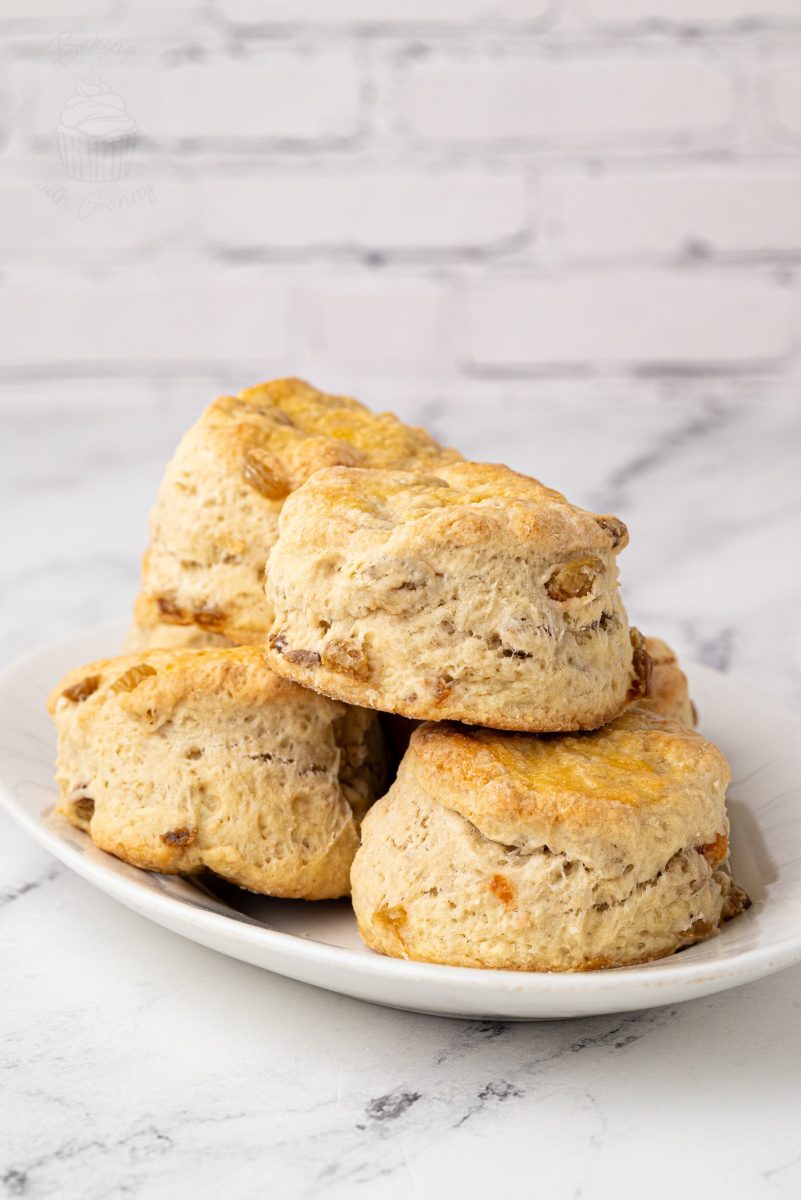 Fruit Scones Freshly baked Fruit Scones on a white plate, perfect for a traditional afternoon tea.
